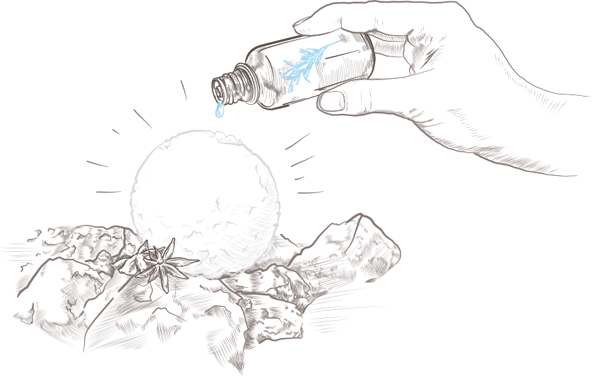 huile essentielle versée sur une boule de neige en train de fondre sur des pierres de saunas